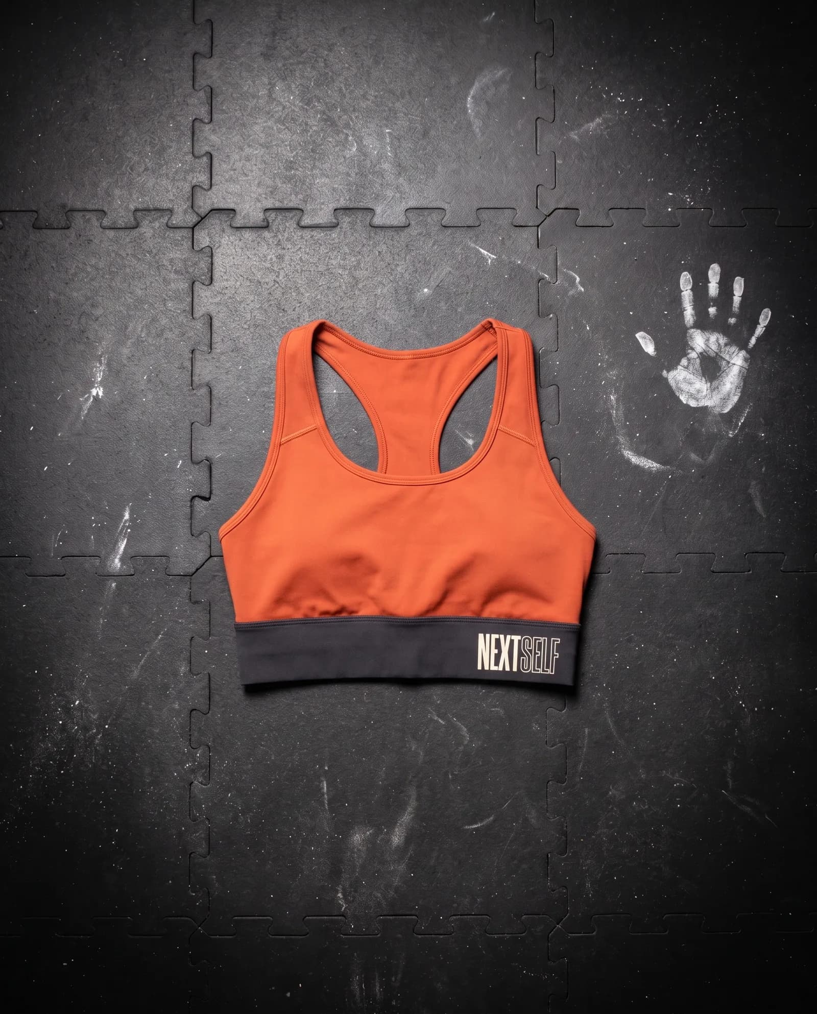 Brace Bra in Carbon, laid flat on a gym floor